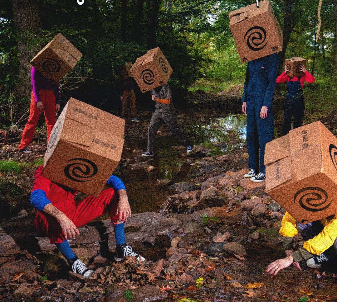 People with Eternal boxes on their heads in a forest